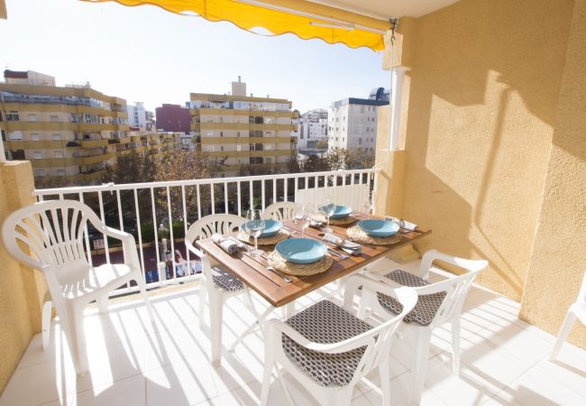 Terrace with table and chairs facing the pool 