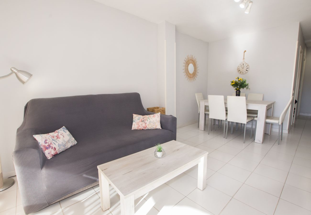 Dining room with wooden table and white chairs